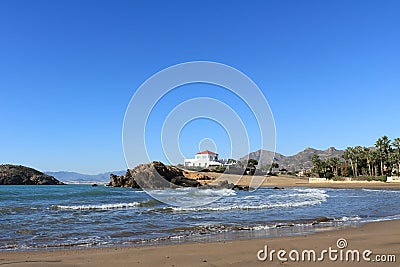 Spanish seascape of a sandy beach with crashing waves Stock Photo