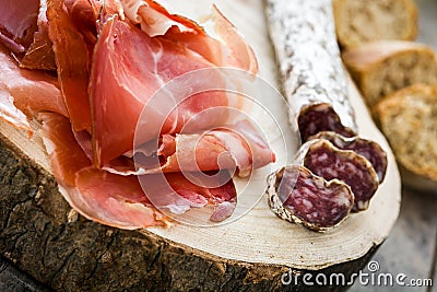 Spanish serrano ham and sausages on a trunk Stock Photo