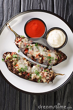 Spanish Stuffed Eggplant Recipe Berenjenas Rellenas close-up in a plate. Vertical top view Stock Photo