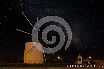 A Spanish windmill at night with the Milky Way galaxy in the sky. Stock Photo