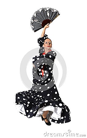 Spanish woman dancing Sevillanas wearing fan and typical folk black with white dots dress Stock Photo