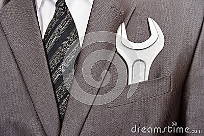 Spanner in businessman suit pocket Stock Photo