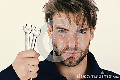 Spanner instrument for fixing or tightening details. Mechanic or plumber with metallic spanner in hand. Stock Photo