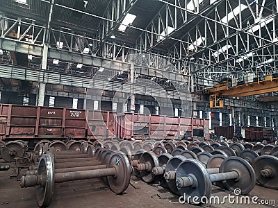 Spare railway wheels on the axle in a repair workshop Editorial Stock Photo