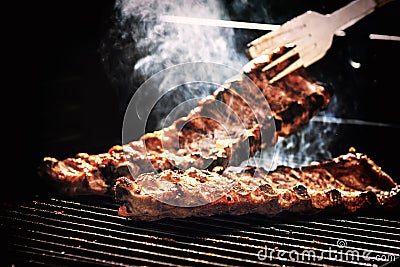 Spare ribs cooking on barbecue grill for summer outdoor party. F Stock Photo