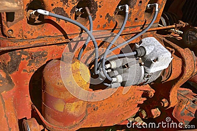 Spark plug wiring of an old orange tractor Stock Photo