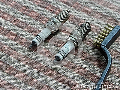 Spark plugs automobile and brush lie on the table Stock Photo
