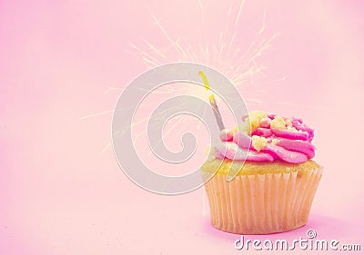 Sparkler on a cupcake pink background Stock Photo