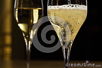 Sparkling champagne in a glass in a dark festive room Stock Photo