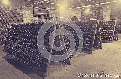 Sparkling wine bottles fermenting in winery cellar Stock Photo