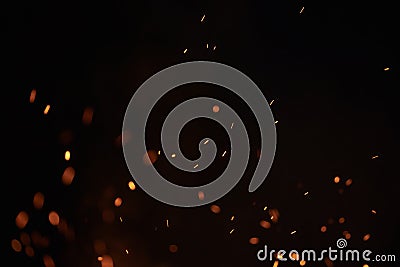 Sparks from bonfire over dark night environment Stock Photo