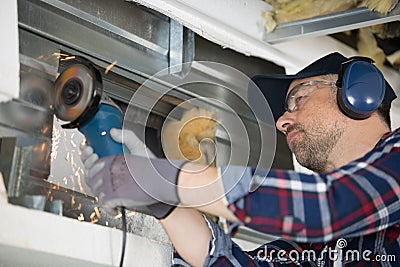 Sparks flying as builder uses angle grinder Stock Photo