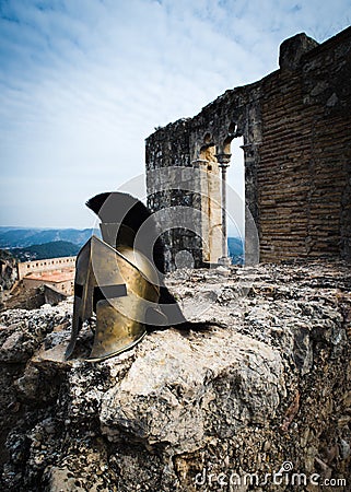 Spartan helmet on castle ruins Stock Photo