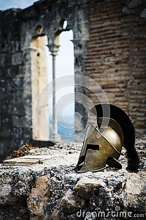 Spartan helmet on castle ruins. Stock Photo