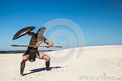 Spartan warrior goes under the shield Stock Photo