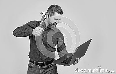 Spate of cyberattack. Hacker assaulting computer with hammer. Targeted cyberattack Stock Photo