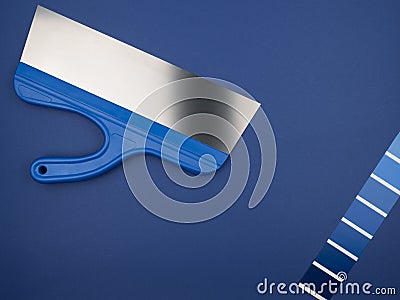 Spatula and palette of colors. Blue on blue. Blue background. Stock Photo