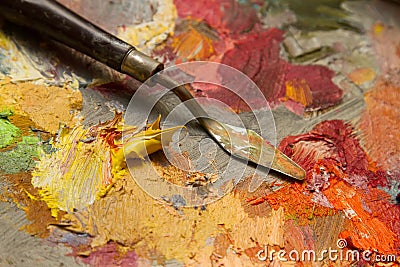 Spatula on a palette with oil paints Stock Photo