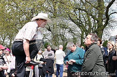 A speaker argues with a man in Hyde Park Corner, London,UK. Editorial Stock Photo