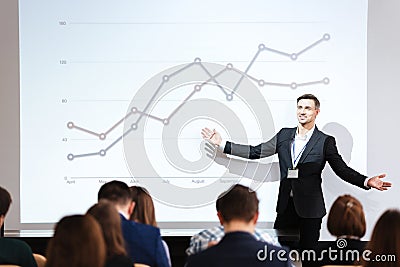 Speaker giving public presentation in conference hall Stock Photo