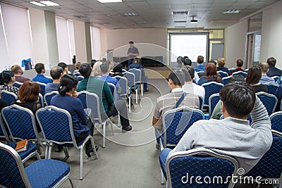 The speaker makes a report at a business meeting. The audience. Business and entrepreneurship, conferences Editorial Stock Photo