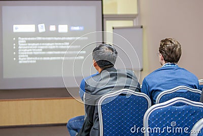 The speaker makes a report at a business meeting. The audience. Business and entrepreneurship, conferences Editorial Stock Photo