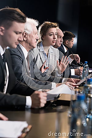 Speakers taking part in press conference Stock Photo