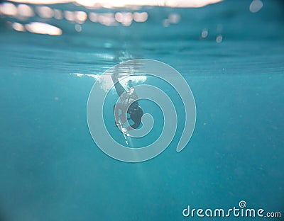 Spearfishing man with flashlight at the top of lake Stock Photo