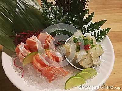 Special Deluxe Combination sashimi set Salmon, Engawa and seaweed on ice sever with wasabi and lime, Japanese food Stock Photo