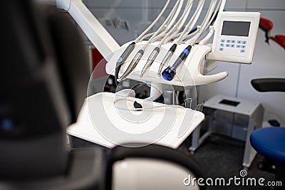 Special dental table with various innovative tools for treating teeth and disarming oral cavity in dentistry cabinet. Stock Photo