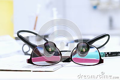 Special dentist's eyeglasses with reflection of young smiing wom Stock Photo