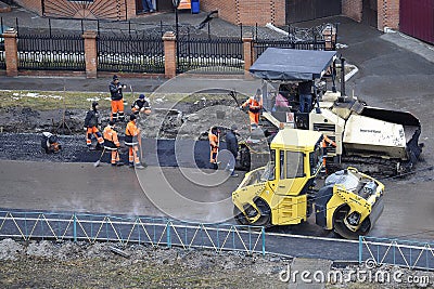 Special equipment on repair of roads. Bulldozer, asphalt spreader Editorial Stock Photo