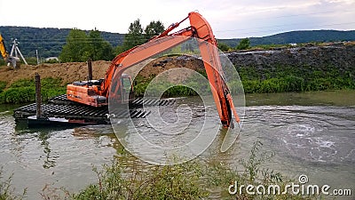 A special floating excavator cleans the canal from the sludge Stock Photo