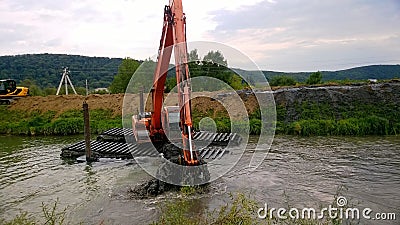 A special floating excavator cleans the canal from the sludge Stock Photo