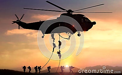 Special force assault team helicopter drops during sunset Stock Photo