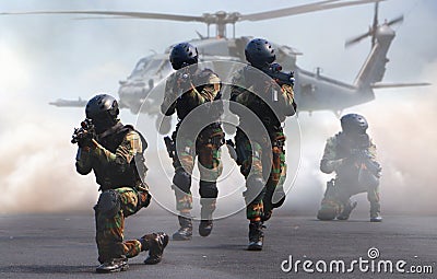 Special force assault team in a mission with helicopter Stock Photo