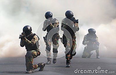 Special force assault team under smoke screen background Stock Photo