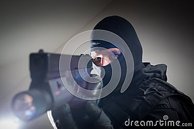 Special forces soldier is aiming and shooting on the target Stock Photo