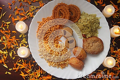 Plate With Traditional Indian Snacks. Maharashtrian Yummy Snacks. Candles Lamps and Decoration. Stock Photo