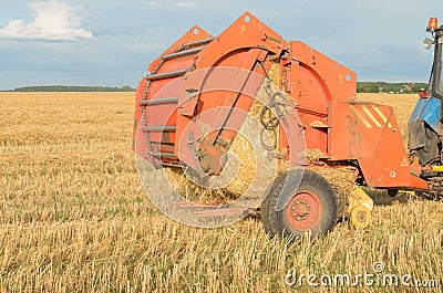 Special machines for harvesting form round bales of hay. Stock Photo