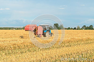 Special machines for harvesting form round bales of hay. Stock Photo