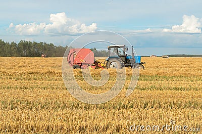 Special machines for harvesting form round bales of hay. Stock Photo