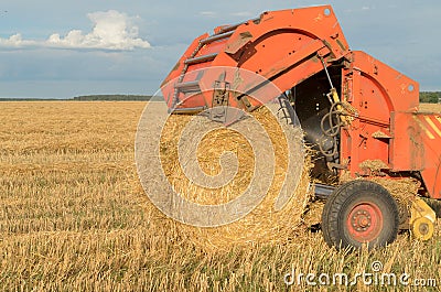 Special machines for harvesting form round bales of hay. Stock Photo