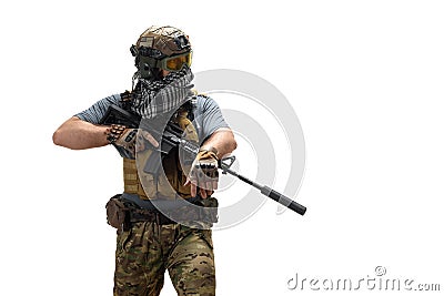 Special Mercenary soldie during a special operation with an automatic rifle standing and looking to copy space. Stock Photo