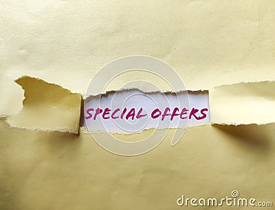 Special Offer appearing behind torn paper Stock Photo