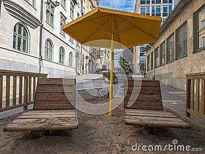 Special scene with sun chairs and umbrella on artificial sand beach Editorial Stock Photo