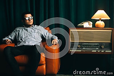 Special secret agent sitting in vintage brown leather armchair with pistol or gun. Spying or intelligence gathering. Espionage Stock Photo