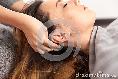 Special therapy. Process of head relax massage. Woman making massage by hands. Stock Photo
