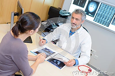 Specialist discussing xrays with patient Stock Photo