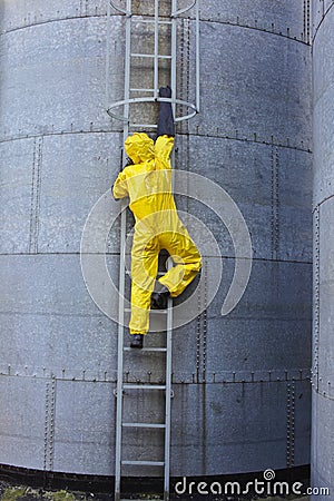 Specialist in protective uniform going up a metal Stock Photo